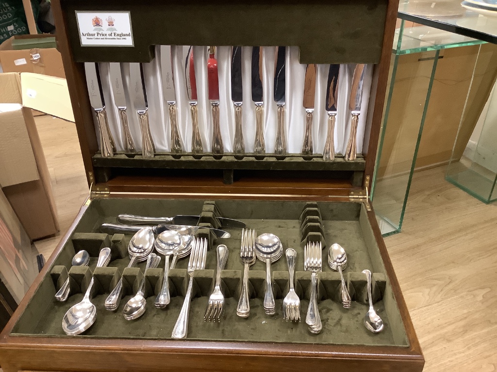 A part service of plated flatware in oak table canteen